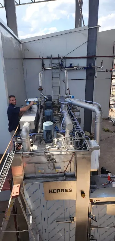 Technician connecting steam and pneumatic piping to the Kerres system