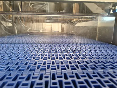 Close-up of the injector’s conveyor belt during commissioning